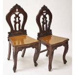 A PAIR OF VICTORIAN WALNUT HALL CHAIRS,