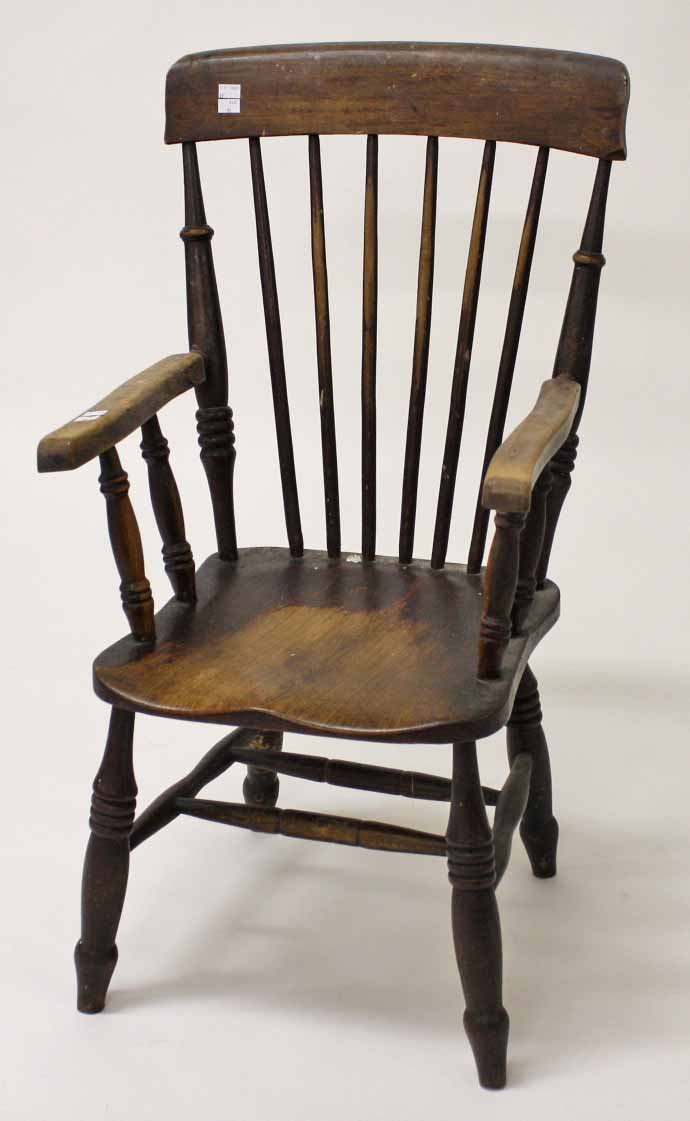 AN OLD ELM AND ASH STICK BACK KITCHEN ARMCHAIR, with solid seat. (1)