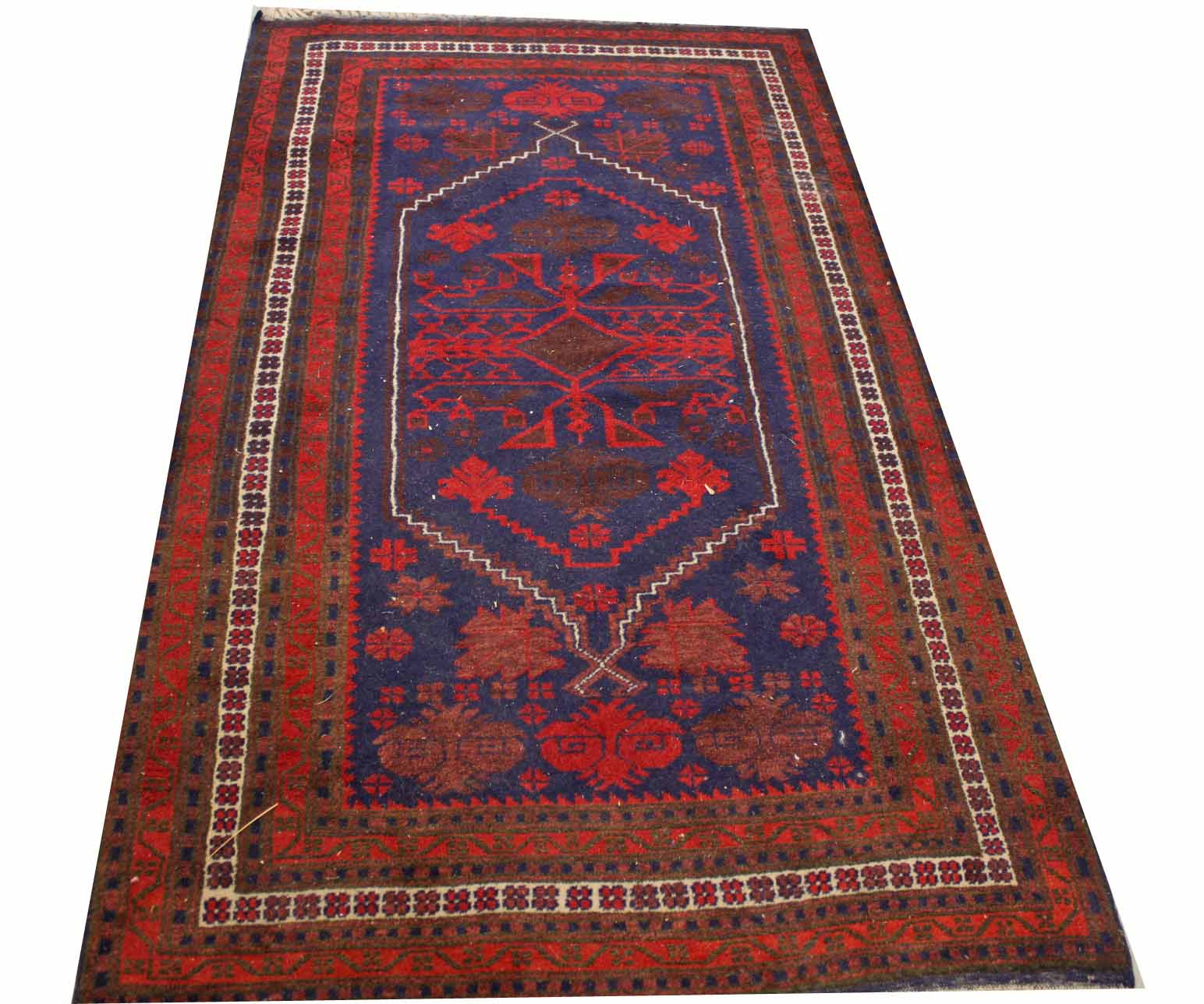 A DARK RED AND BLUE GROUND TURKISH RUG,