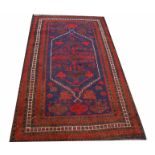 A DARK RED AND BLUE GROUND TURKISH RUG,