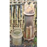 A CORONA TOP TERRACOTTA CHIMNEY POT, with half reeded body, 44.5in (113cm)h; and another smaller