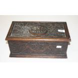 A RECTANGULAR CARVED OAK BOX, Early 20th century, the top carved with sprays of flowers and a