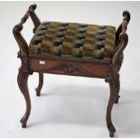 AN EDWARDIAN WALNUT PIANO STOOL,   with