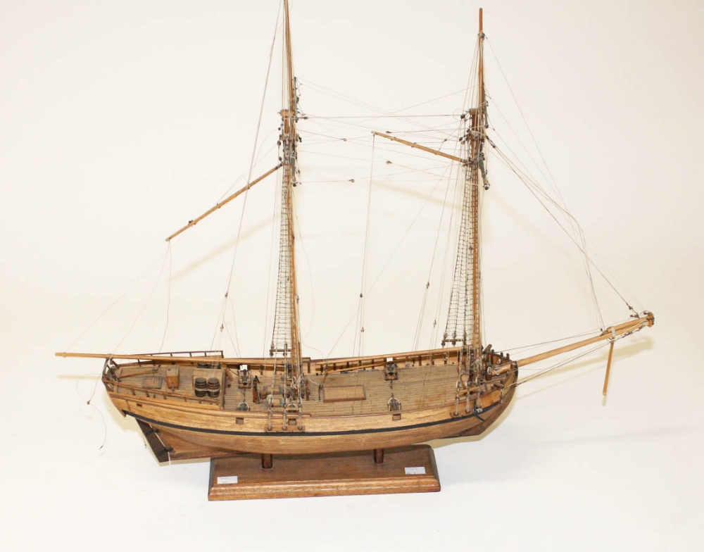 A WOODEN SCALE MODEL OF A DOUBLE MAST SCHOONER, with riggings, wooden deck with six cannon guns,