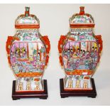 A PAIR OF CHINESE FAMILLE ROSE PORCELAIN VASES AND COVERS, O.R.M, each with a temple lion surmounted