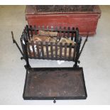 A CAST STEEL BASKET GRATE, of rectangular form with slated sides with arched steel fire back and two