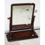 A mahogany swing frame dressing table mirror, Victorian, with scroll shaped supports on a plinth