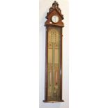 AN UNUSUAL ADMIRAL FITZROY'S BAROMETER, in the Gothic style, the arched top inset with a time piece,