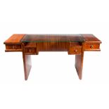 AN ART DECO STYLE WALNUT SIDE TABLE, with glass top, above an arrangement of four drawers, on