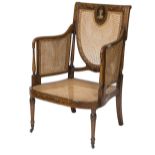 AN EDWARDIAN SATIN WOOD BERGERE ARMCHAIR