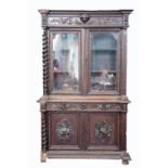 A HEAVY 17TH CENTURY STYLE OAK LIBRARY BOOKCASE, 19th century, the moulded cornice above a frieze