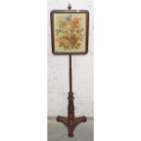 A VICTORIAN POLE SCREEN, with floral tapestry panel, on baluster reeded stem and triform base,
