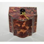 A FAUX TORTOISE SHELL AND WHITE METAL INLAID TEA CADDY, with serpentine shaped front, under a hinged