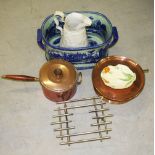 A HEAVY COPPER SAUCEPAN ON A WARMING STAND, together with a modern blue and white stoneware two