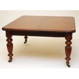 A VICTORIAN MAHOGANY TELESCOPIC DINING TABLE, with three spare leaves, the nicely figured and