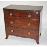 A BOW FRONTED MAHOGANY CHEST,   two long