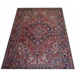 A PERSIAN SEMI ANTIQUE HERIZ RUG,