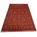 A DARK RED GROUND ORIENTAL RUG, with two rows of medallions, inside a conforming border, 80in (