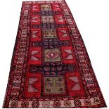 A HANDMADE PERSIAN RUNNER,