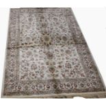 A KASHMIR RUG, 
with ivory ground and floral field inside three conforming borders,