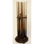 A VICTORIAN TWENTY ONE CUE STAND, 
with turned uprights and ball finials,