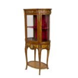 A FINE BRASS MOUNTED WALNUT VITRINE, with bowed glass sides and a central door,