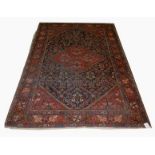 A BIIDJAR RUG, 
with iron red diamond medallion, on a navy floral field inside an iron red border,