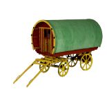 A SCALE MODEL OF A BARREL TOP GYPSY CARAVAN, the roof and sides covered in green felt,
