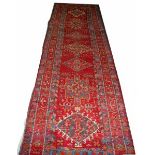 A KARAGA RUNNER, 
the Burgundy ground with central medallions, inside a four band border,