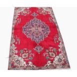 A BURGUNDY GROUND TABRIZ RUG, 
with large centre medallion and ivory spandrel's,