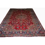 A SABZEVAR RUG, 
with centre star medallion on a floral burgundy ground,