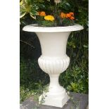 A PAIR OF HEAVY CAST IRON GARDEN URNS, 
each with egg and dart cast rim, the half reeded body,