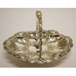 A LATE VICTORIAN OVAL CHASED SILVER SWING HANDLE CAKE BASKET,