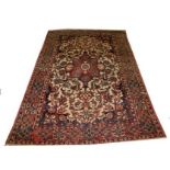 AN ISFAHAN RUG, 
with centre red medallion, on a floral ivory ground inside an iron red border,