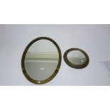 AN OVAL COPPER FRAMED MIRROR,