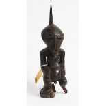 AN ANTIQUE GUARDIAN SONGYE NKISI, Angola/DRC, in hardwood, great patina, old damage, 38 x 13cm.