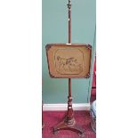 A VICTORIAN MAHOGANY POLE SCREEN,
with tapestry panel on tri-form base.