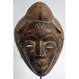 A PUNU LUMBO FOREHEAD MASK, 
Gabon, with antique hairstyle, dark stain, 39cm high, 28.