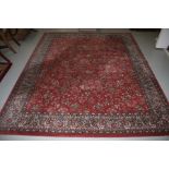 AN ATTRACTIVE ORIENTAL STYLE IRON RED GROUND MACHINE MADE FLORAL RUG,