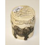 A JAPANESE IVORY BOX AND COVER,
profusely carved in relief, with six tigers and a rhinoceros, 3.