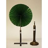 AN UNUSUAL GREEN COCADE FAN, 
with telescopic brass stem, on a reeded bronze folding base,