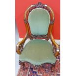 A VICTORIAN WALNUT ARMCHAIR, 
the pierced and moulded back,