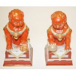 A PAIR OF IRON RED GROUND TEMPLE LIONS, 
O.R.M., each on a rectangular moulded fixed plinth, 13.