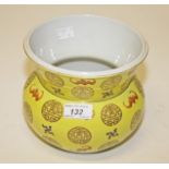 A CHINESE PORCELAIN YELLOW GROUND BOWL OR VASE, 
decorated with bats, swastikas and roundels,