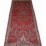 A HAMADAN RUG,
with iron red field and all over stylized floral field,