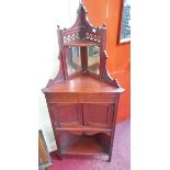 AN EDWARDIAN WALNUT CORNER CHIFFONIER,
with two mirror plates and two cupboard doors,