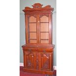 AN ART NOUVEAU WALNUT BOOKCASE, 
with shaped pediment,