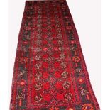 A BOKHARA RUNNER, 
with two rows of octagons, on a burgundy ground, within a dark navy border,