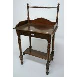 A LATE 19TH CENTURY MAHOGANY WASH STAND, 
the back with a turned rail and three quarter gallery,