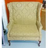 A SMALL TWO SEATER WING BACK SETTEE, 
on front cabriole legs.